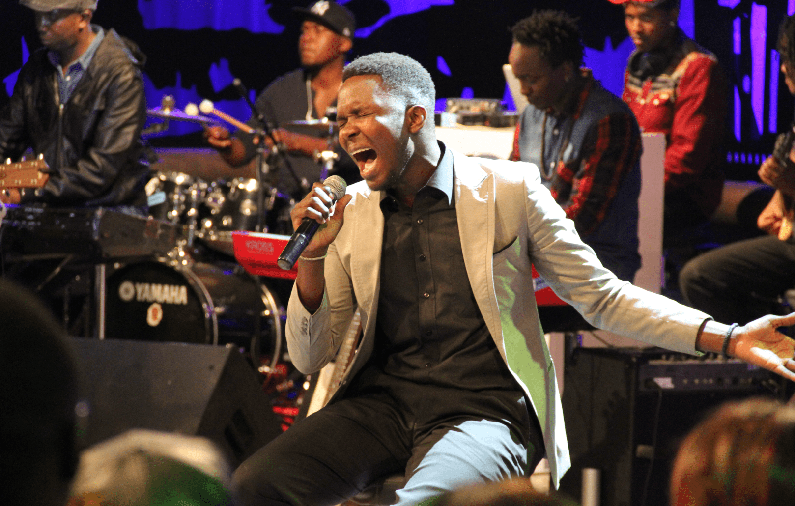 Woman with dreadlocks looking over her shoulder in a crowd